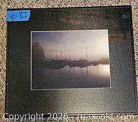 Front view of framed foggy boat photograph
