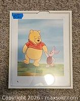 Front view of framed Winnie the Pooh and Piglet print showing cracked frame