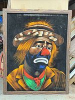 Front view of framed sad clown painting on black velvet