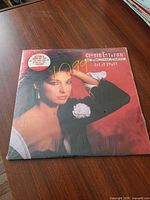 Front album cover in shrink wrap with price sticker