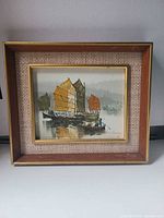 Frontal view of framed oil painting showing subject, signature and frame detail