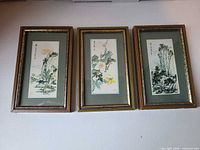 Front view of the three framed paintings