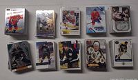 Eleven visible stacks of NHL hockey cards showing various players and brands