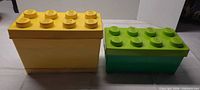 Yellow and green brick-shaped storage boxes, lids closed