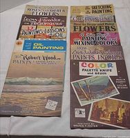 11 booklets laid out, full view of covers