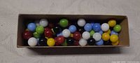 Top view of marbles in cardboard tray