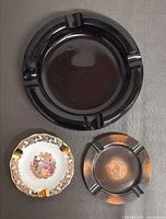 Group view of all three ashtrays: glass, porcelain, metal