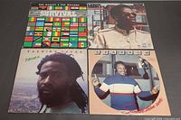 Four reggae album covers laid out together
