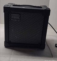 Front view of Roland Cube-15 combo amplifier showing grille and logo