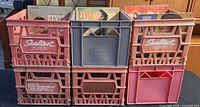 Front view of six stacked plastic dairy crates filled with records