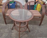 Set overview showing two barrel chairs with striped cushions and matching round glass-top table