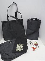 All totes, slipcover and keychains arranged to show full lot