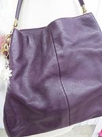 Front view of eggplant Coach tote showing leather texture