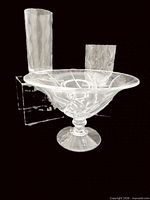 Overview of three clear glass pieces: pedestal bowl, tall cylindrical vase, shorter wavy vase