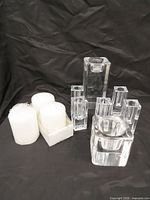 All glass candleholders and pillar candles grouped together