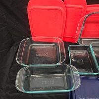 Assorted Pyrex clear glass dishes and red lids