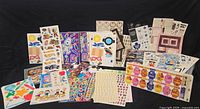 Front view of entire lot showing storage case, album and numerous sticker sheets