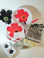 Group shot of entire lot showing Marimekko dinnerware, flatware tray, candlestick pieces and candles