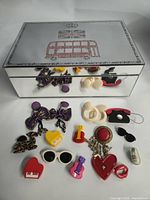 Front view of mirrored jewelry box and scattered costume jewelry items