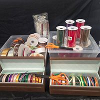 Overview of ribbon spools, scissors and storage boxes