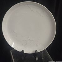 Front view of white Rosenthal Cumulus porcelain plate showing embossed cloud pattern