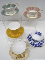 Front view showing all five cup and saucer sets