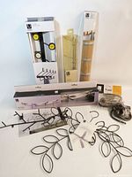 All items grouped together showing boxed Flip wall racks, vine hangers, curtain rings and hardware