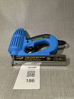 Full view of blue Arrow ET100M brad nail gun showing body and cord