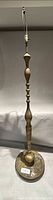 Full view of tall brass lamp showing overall form