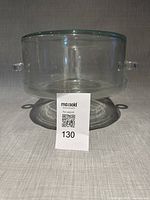 Cylindrical glass cover showing loop handles