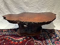 Full view of redwood burl slab coffee table showing top surface and live edge