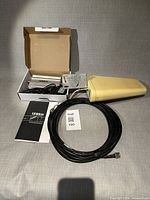 Full kit laid out: indoor amplifier, power adapter, Yagi antenna, coaxial cable, manual