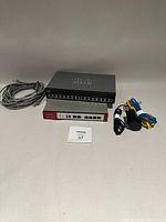 Overview of Cisco switch, ZyXEL gateway, power adapter and cables