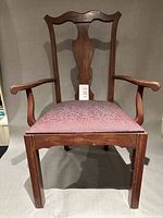 Front view of custom wood armchair with mauve upholstered seat