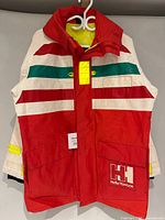 Front view of jacket showing colour pattern, pockets, logo