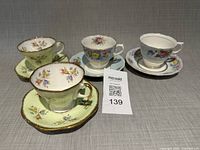 Four teacup and saucer sets displayed upright