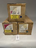 Three sealed Forecast boxes labeled F4715-36 with halogen bulb included