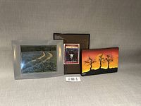 Group shot of three framed artworks standing together