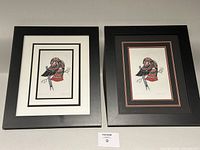 Both framed prints side by side