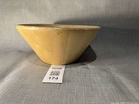 Side view of round wooden bowl showing exterior shape and finish