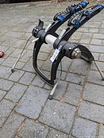 Front angle of Thule trunk bike rack showing dual arms and cradle straps