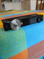 Top view of black metal rangefinder showing silver distance dial