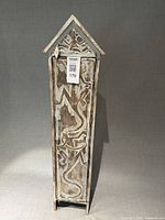 Front view of tall carved wooden CD storage tower