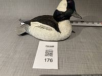 Left side view of carved duck showing paint and feather detail