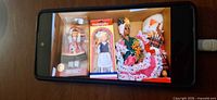 Overall view showing two boxed Nationality dolls and two unboxed dolls in national costumes