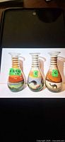 Front view of three desert sand art glass vases