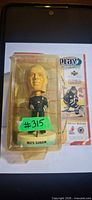 Front view of packaged Mats Sundin bobblehead showing figure, yellowed blister, backing card graphics and base label