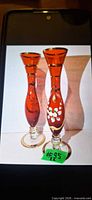 Both ruby red Bohemian bud vases front view