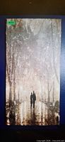 Full view of framed canvas showing couple walking under illuminated trees