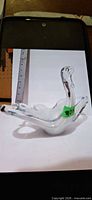 Front view of clear and white glass swan
